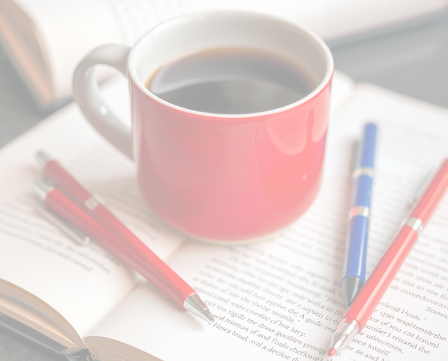 coffee mug, pens, red,, blue, and black, on books_edited_edited.png