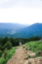 girl climbing mailbox peak trail with north bend in the background