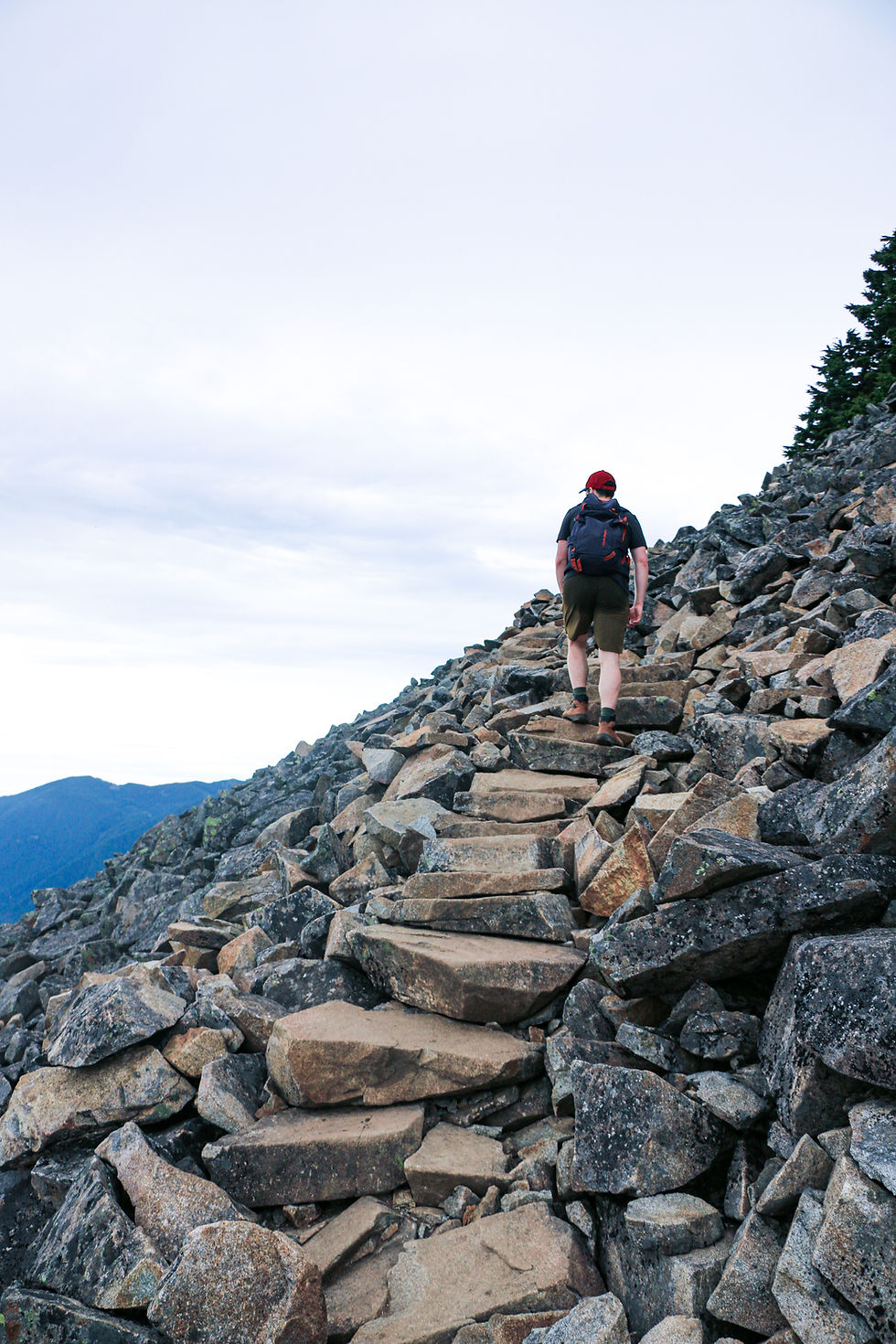 Man walking on rock steps on mailbox peak trail