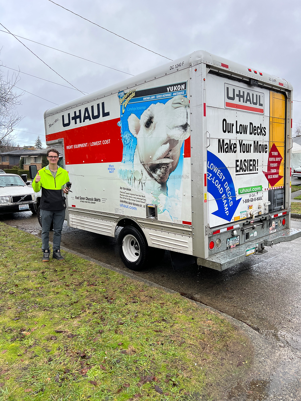man standing next to u-haul