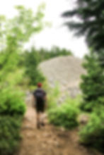 Man walking into a talus deposit on Mailbox Peak Trail