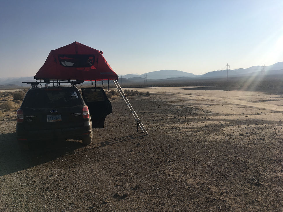 A car parked with a rooftop tent