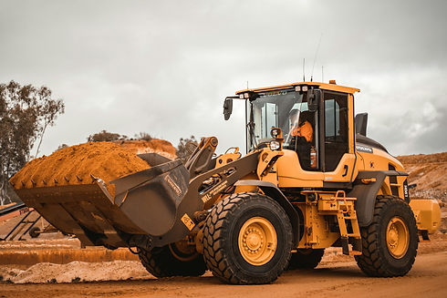 Wheel loader carrying a full bucket of dirt on an Australian mine site