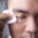 A man is wiping his eye lids