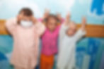 Children with childhood cancer making peace signs.