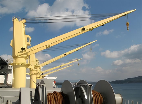Marine deck crane lifting cargo on a ship's deck in rough seas