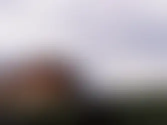 Picture of a house on a grassy hillside.