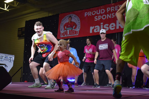 cardinal crew kid on stage with dancers