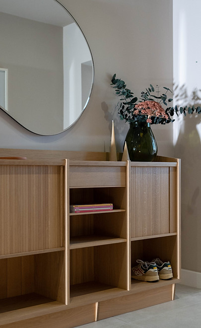 Oak sideboard with tambour doors in a contemporary hallway