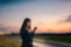 mkc-female-using-digital-tablet-while-examining-a-highway-at-dusk.2000.1033.lossy.90.webp