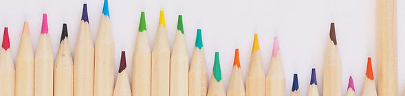 colored pencil lined up on top of white