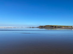 Beara Lodge Glamping Devon nearby Widemouth Bay Bude view across beach calm sea