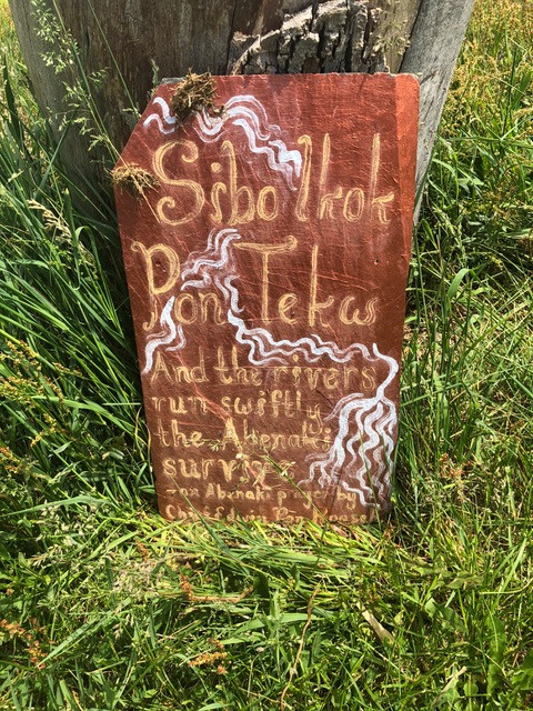 — Plaque bearing a fragment from an Abenaki prayer reading Sibo ikok pon tekw, “And the rivers run swiftly, the Abenaki shall survive.” From Knoll Hill Farm retreat center near Waitsfield, VT. Photo: Richard Knox