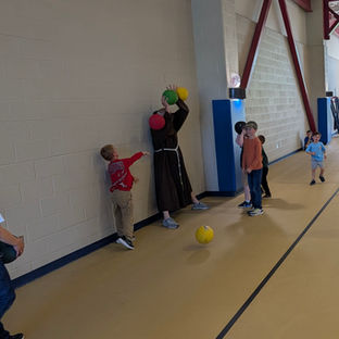 Father Francis playing Dodge Ball
