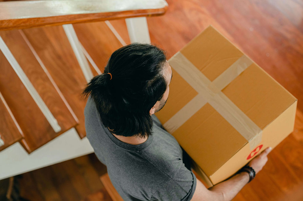 Man Carrying a Box in a New Apartment