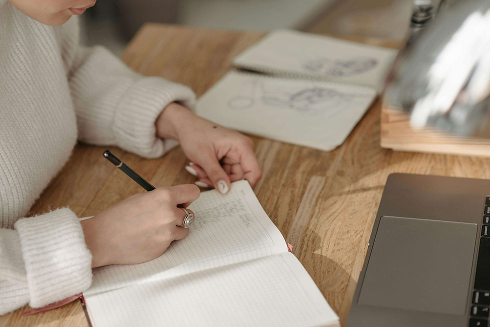 A Person Writing on White Paper