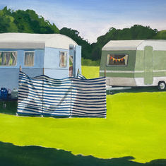 Two vintage caravans, one with a striped windbreak.