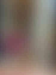 Woman leans out of mosaic columns