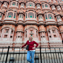 A woman stands outside Hawa Mahal