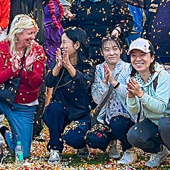 Women smile and celebrate sunrise together