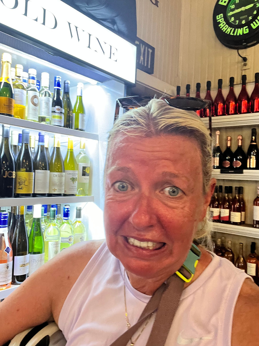 A selfie in front of a wine cooler.