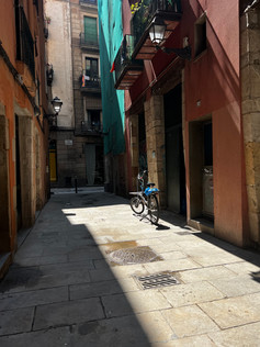 A bike in the shadows of an alley