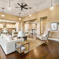 Spacious living room, white couch, and modern decor. Crisafulli Team. 
