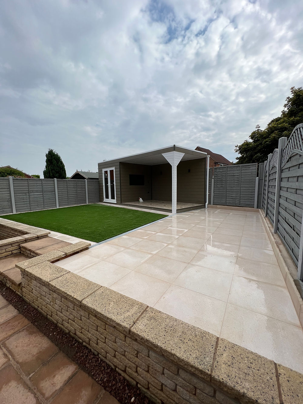 Modern garden room with patio and grass.