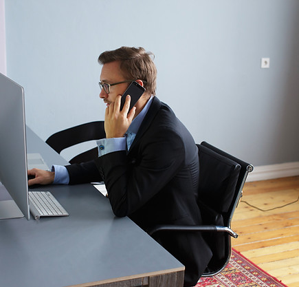 young-business-man-speaking-phone-office.jpg