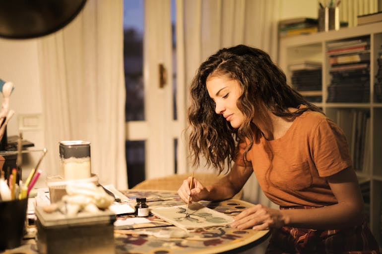 a woman painting in a small room