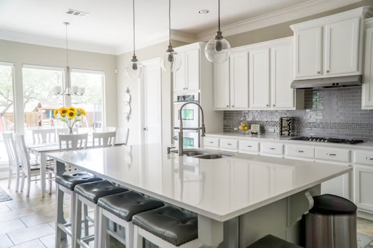 A white kitchen counter and white cabinets