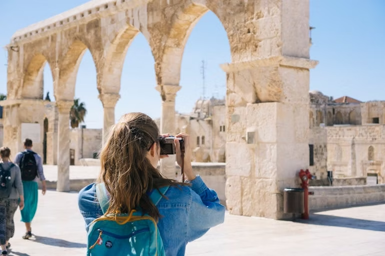 a woman taking photos at a historic site