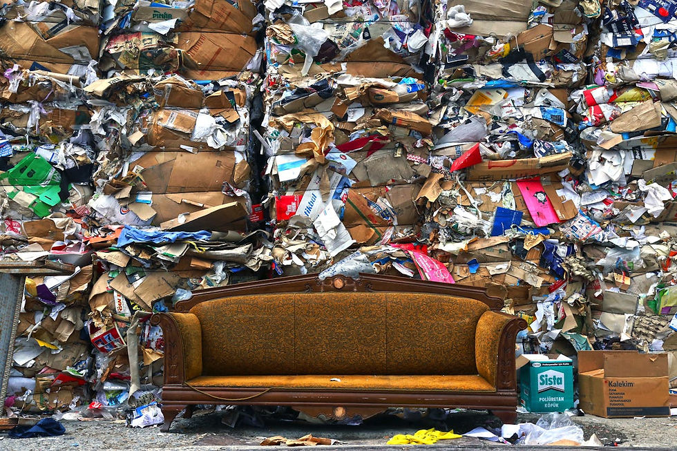 Brown sofa with piles of compressed rubbish