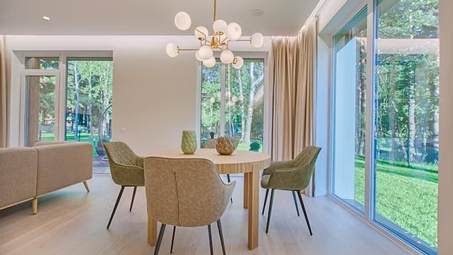 A dining table and four chairs in a room