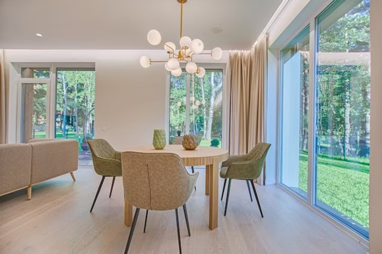 A dining table and four chairs in a room
