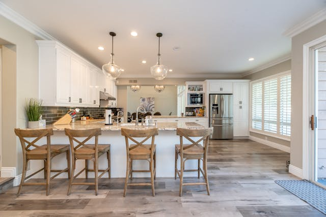 Four wooden chairs near a kitchen counter