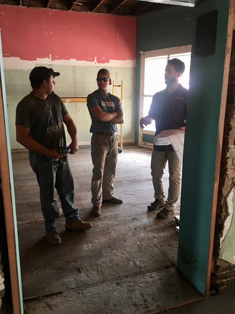 Will King, Adam Kelley, and Josue Rivas discuss the plans at the House of Vacuums