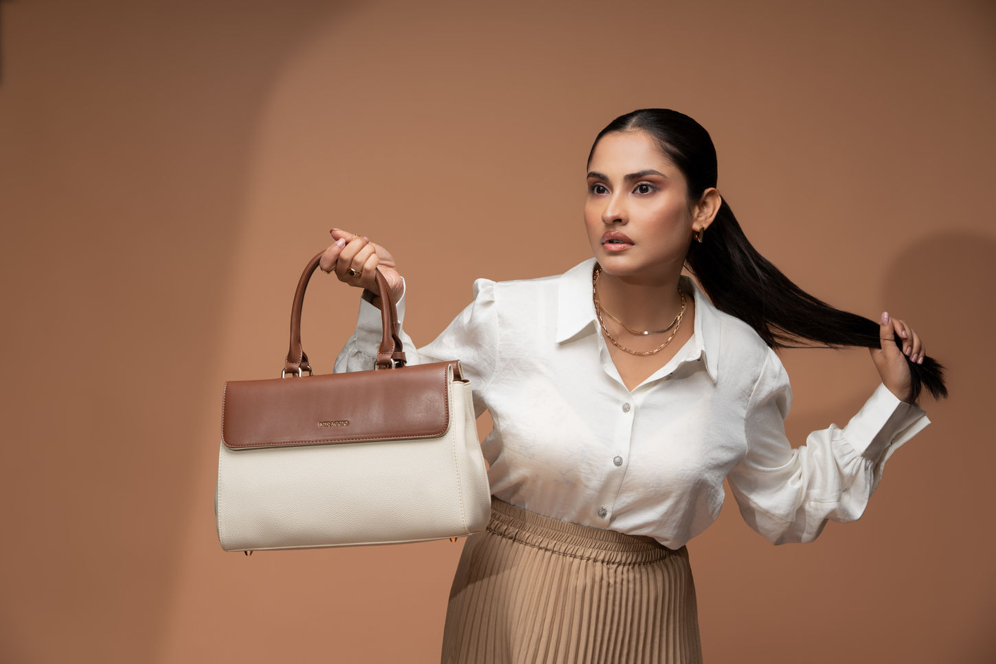 Side profile of the Miraggio handbag to show depth and capacity in a commercial context.