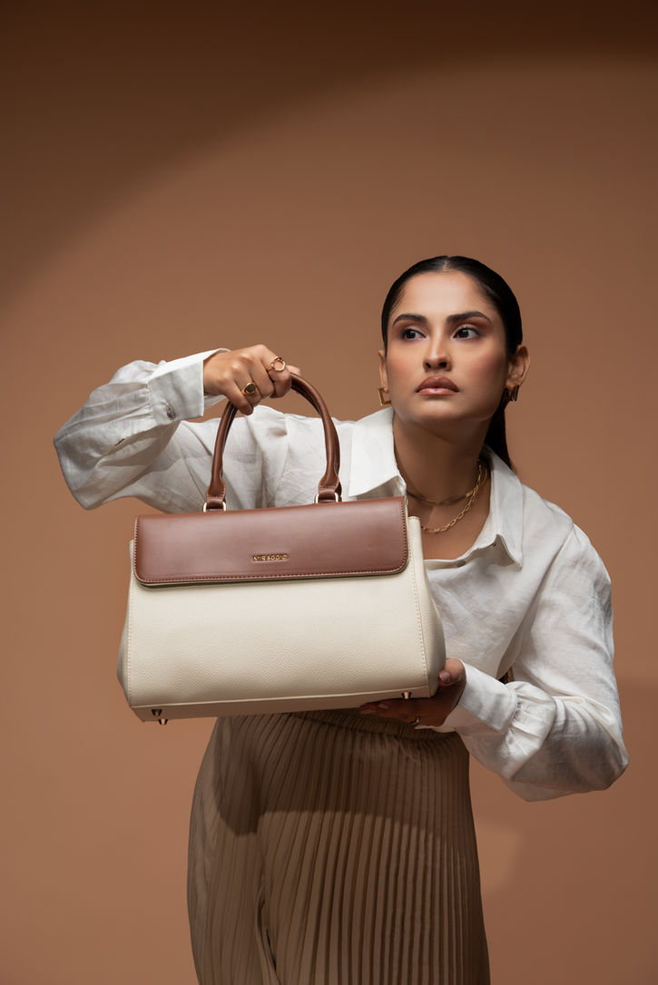 Detailed product shot of the Miraggio handbag hardware and leather texture for advertising.