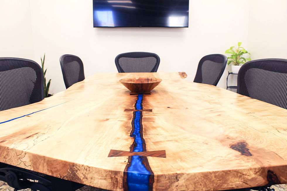 Eye-level view of a rustic meeting space with wooden tables and natural light in Harrisonburg