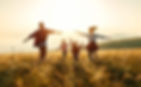family-running-through-field.jpg