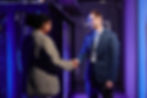 waist-up-portrait-two-business-partners-shaking-hands-while-standing-data-center-interior.