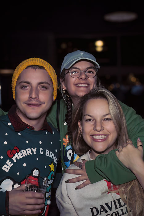 Friends in a cozy setting, smiling and celebrating together during a social event.