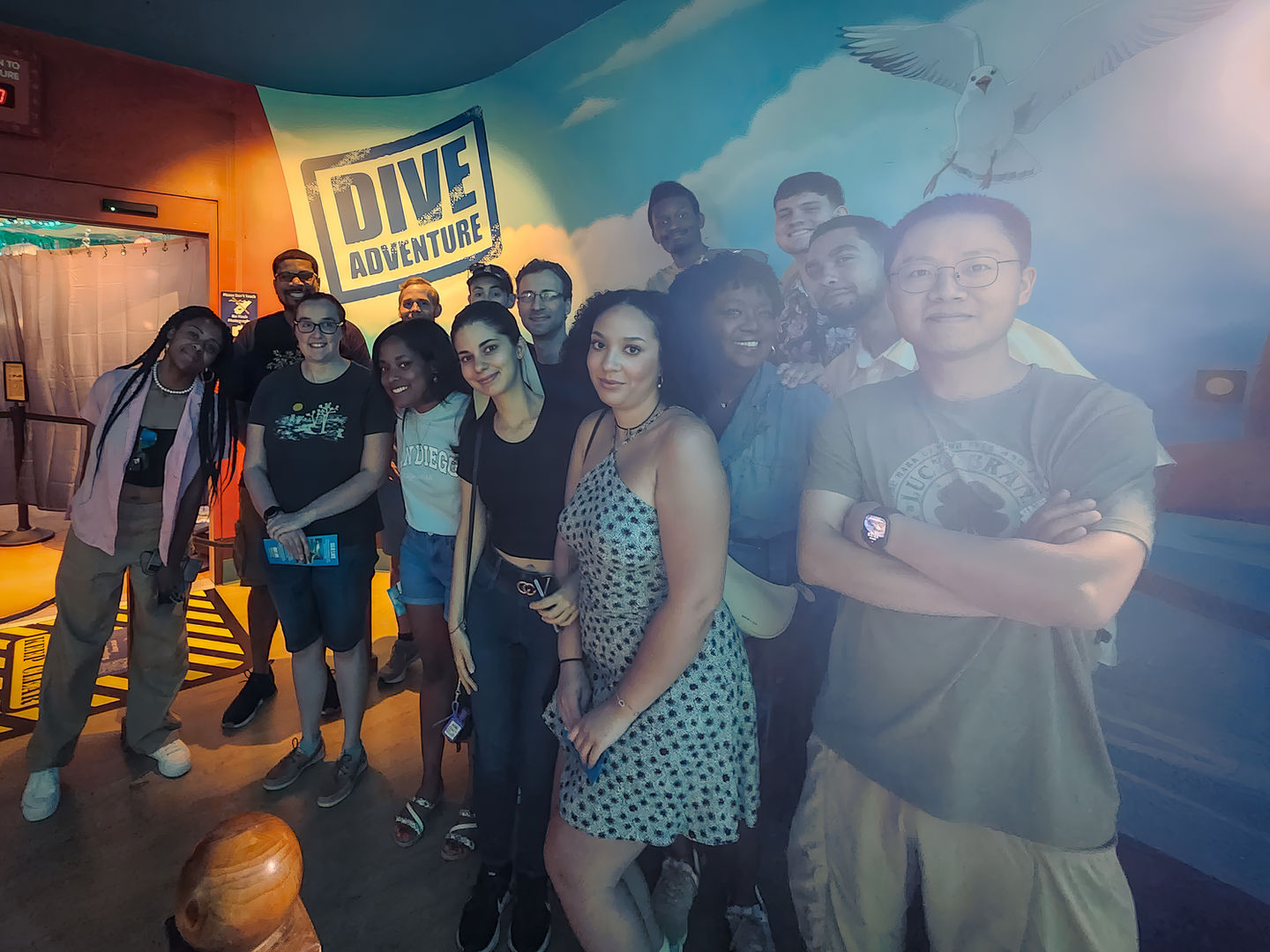 Friends posing together at a lively indoor venue, enjoying drinks and fun.