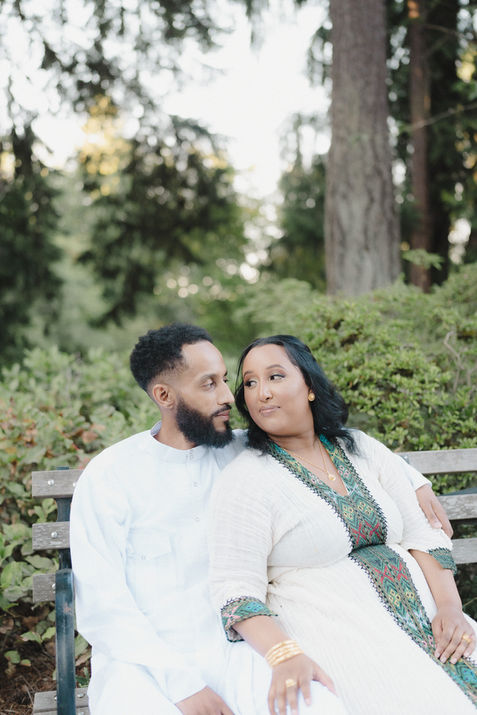 A couple sitting on a bench. 