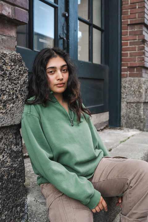 A young woman siting on steps. 