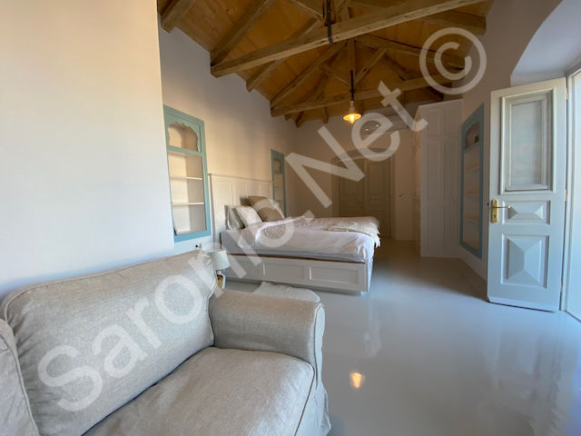 Attractive and spacious Air Conditioned Double bedroom with beautiful vaulted ceiling with large platform bed. Unusual framed inset shelving and seating area