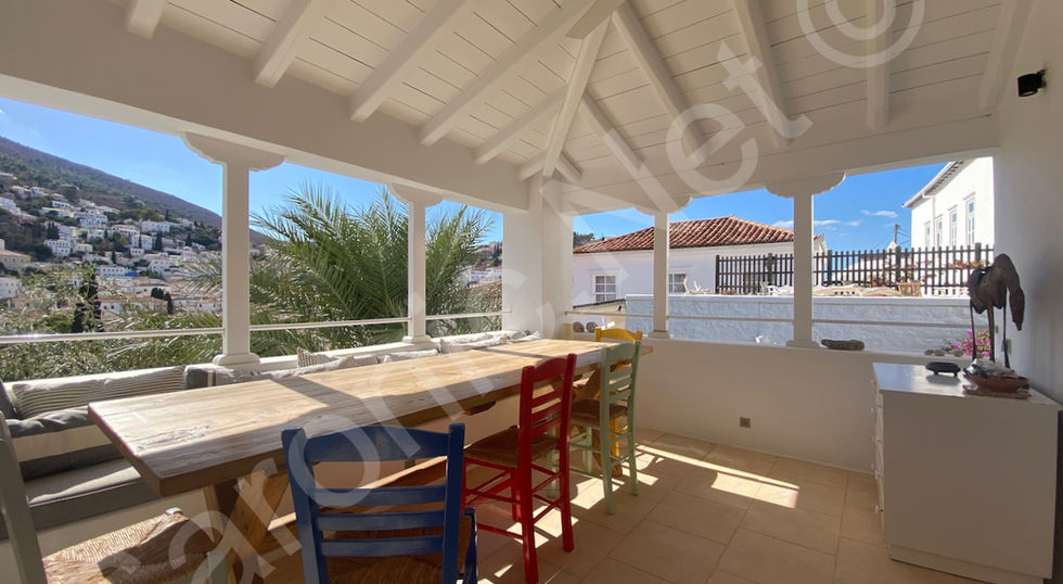 large dining table on terrace from kitchen, looking across to living room terrace