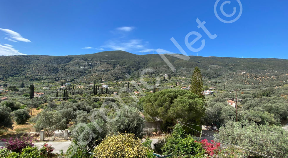 House set with extensive enclosed gardens and views across the hillside and lemon trees of Galatas