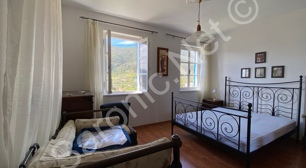 Good sized double en suite Bedroom 4 with polished wood floors and 2 big windows looking out to spectacular views